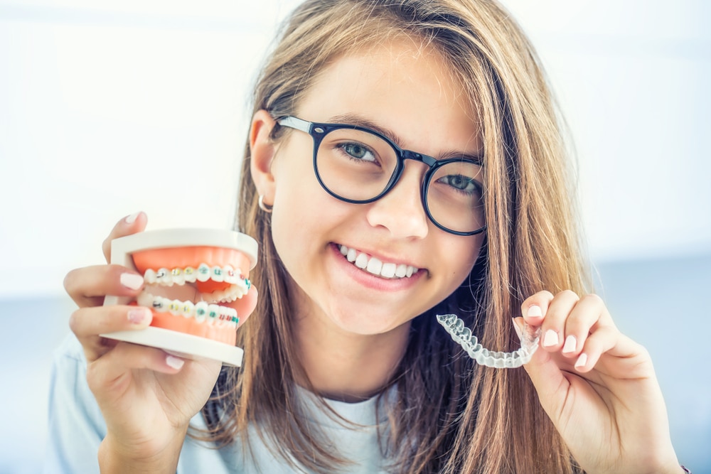 invisalign vs traditional braces Genesis Dental and Orthodontics dentist near me, children's dentistry, pediatric dentistry, family dentisry, general dentistry, cosmetic dentistry, braces, metal braces, traditional braces, invisalign, clearcorrect, clear aligners, damon brackets, emergency dental dentistry, dental implant, implants, crown, crowns, cerec, filling, fillings, sealant, sealants, bond, bonding, frenectomy, gum recontouring, root planing, dentures, partial denture, full dentures, implant retained denture, cracked tooth, loose teeth, discolored tooth porcelain fillings, tooth-colored amalgam fillings, dental exam, xray, cleaning, cleanings, teeth whitening, zoom whitening, dentist open on saturday, dentist open on sunday, emergency dentist serving utah and kansas, serving SALT LAKE CITY, UT,TAYLORSVILLE, UT, SOUTH JORDAN, UT, OREM, UT, MAGNA, UT, WEST VALLEY CITY, UT, DISTRICT ORTHODONTICS UT, BRIGHT SMILES DENTAL UT, THANKSGIVING POINT, CENTRAL AVE DENTAL KS, OVERLAND PARK, KS